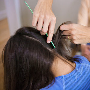 child with long dark hair receiving a head lice check in concord, ca